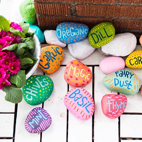 Colourful painted rocks with herb and plant names on them