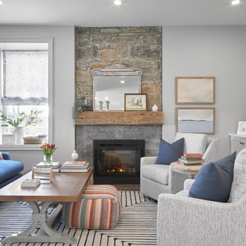 Living room with stone fireplace and white couches