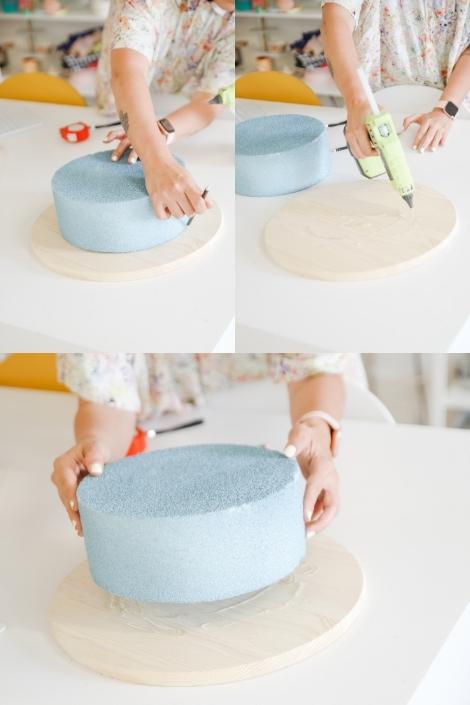 A collage of photos of Maca measuring out the shape and size of the Styrofoam cake form on the wooden plaque, adding hot glue., and sticking the two pieces together.