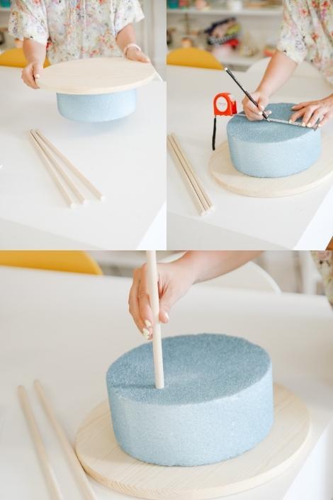 A collage of pictures showing Maca fitting the round wooden plaque atop the Styrofoam cake form, taking measurements, and inserting the dowels.