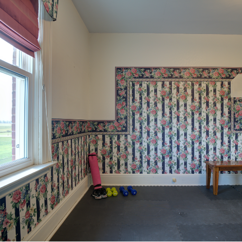 Empty room with ugly floral wallpaper