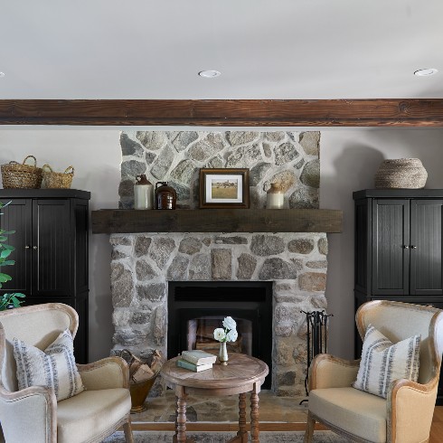 Stone fireplace with wood mantel in a lounge area