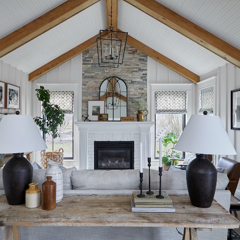 Living room with exposed beams and stone fireplace