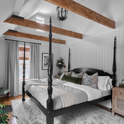 Principle bedroom with exposed beams and an antique lantern