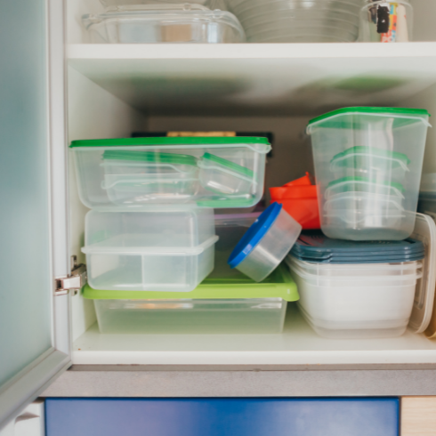 Feng Shui tips: Tupperware paired with lids, neatly stacked in a kitchen cabinet.