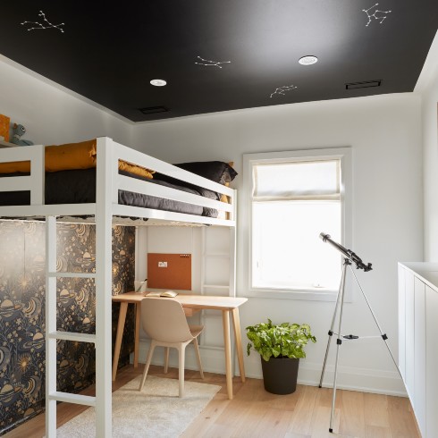 Children's bedroom with loft bed and stars on ceiling