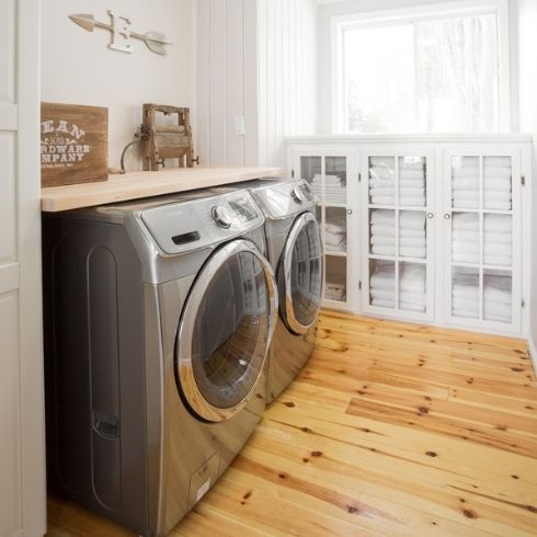 A washer and dryer in a light-filled laundry room