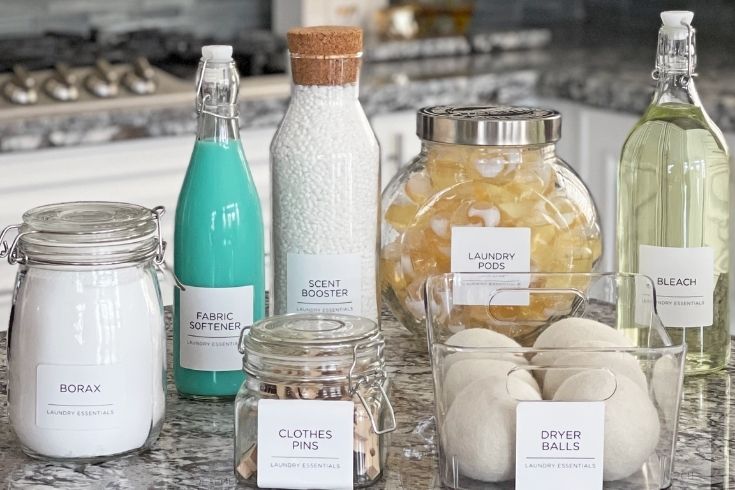 Various laundry room supplies in glass containers. 