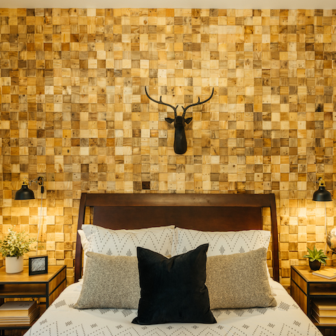 Bedroom with a wood pallet feature wall and warm lighting