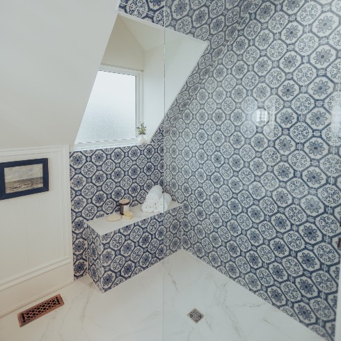 Walk-in shower with blue and white tile