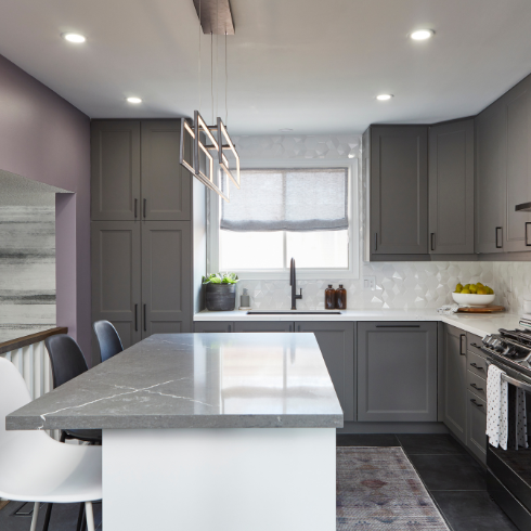 Renovated kitchen with grey cabinetry and a large kitchen island