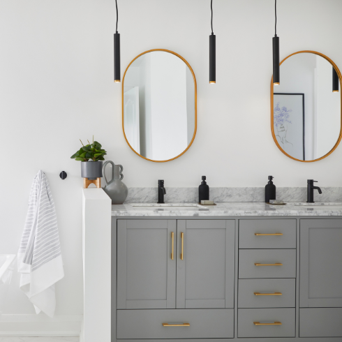 Modern bathroom with a double vanity and black pendant lights