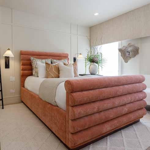 Renovated bedroom with padded pink bed frame