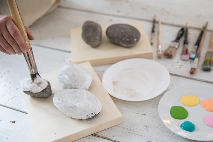 White painted rocks and paint supplies