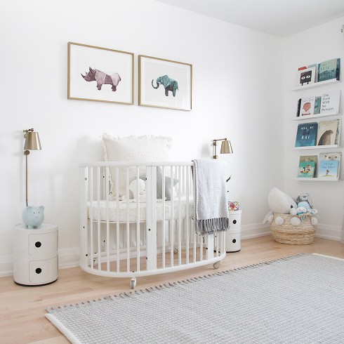 White nursery with white crib and animal prints