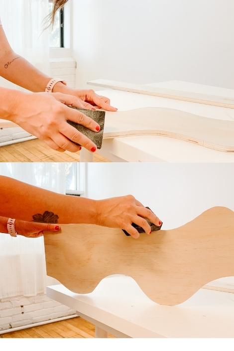 A person sanding a wavy shelf 