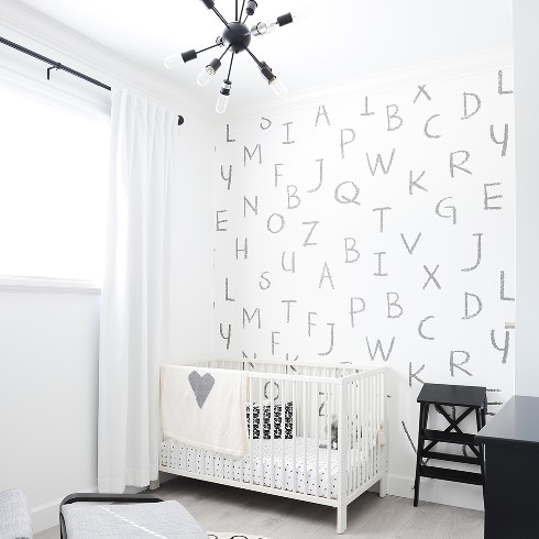 White Nursery with alphabet printed wallpaper