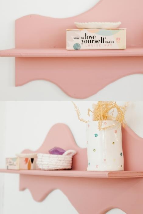 A wavy pink shelf with pieces of decor