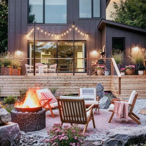 Backyard for entertaining with fire pit and deck, and string lights
