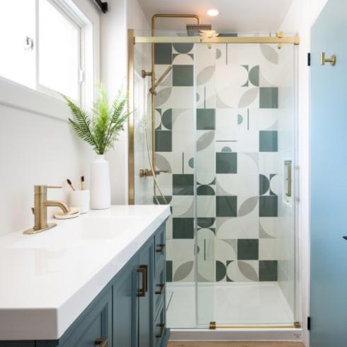 Blue bathroom vanity sink, blue doors and multi-coloured tiles