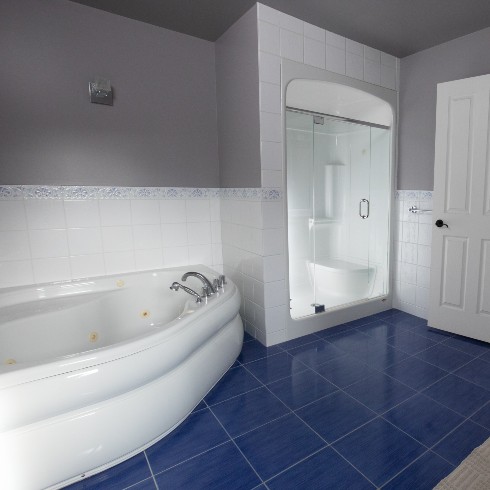 Spacious primary bathroom with jacuzzi tub and shower