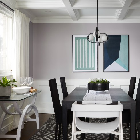 Dining room with modern light fixture and art