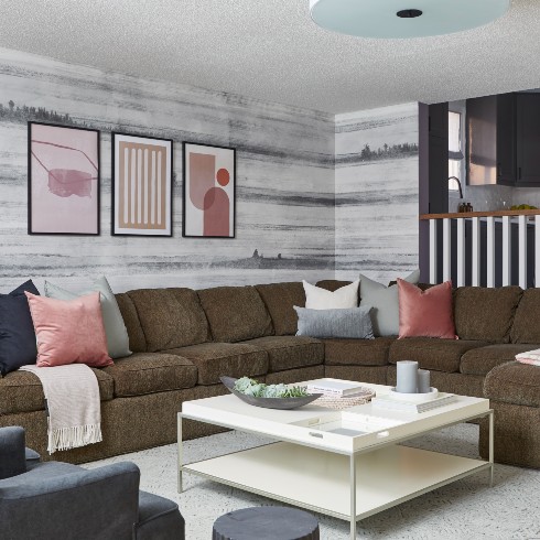 Sunken living room with large sectional and pink accents