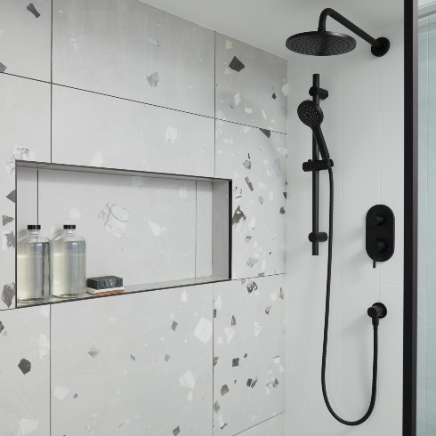 Bathroom shower with grey stone and matte black hardware