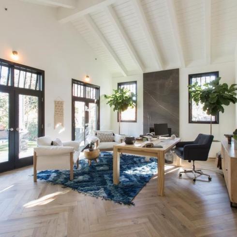 Light wood herringbone floors in big home office