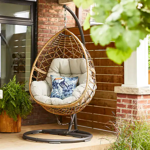 A hanging egg chair in a tear-drop shape.