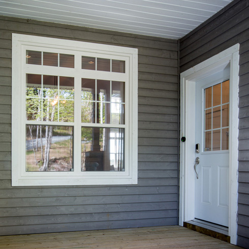 single hung windows with above transoms and rectangular grilles