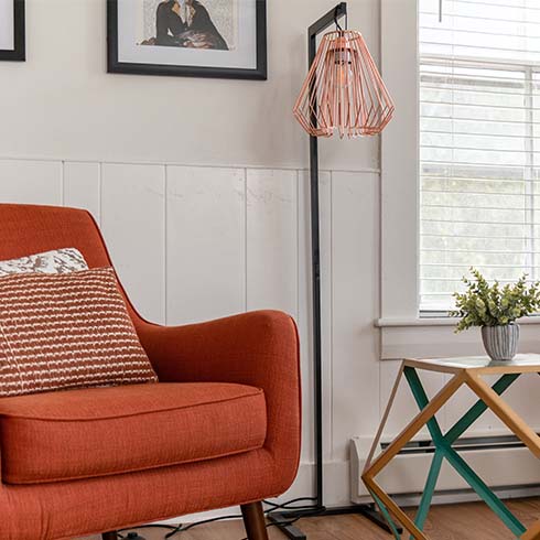 Orange arm chair with industrial light.