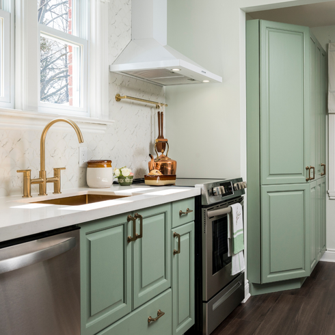 Sage green kitchen with gold accents