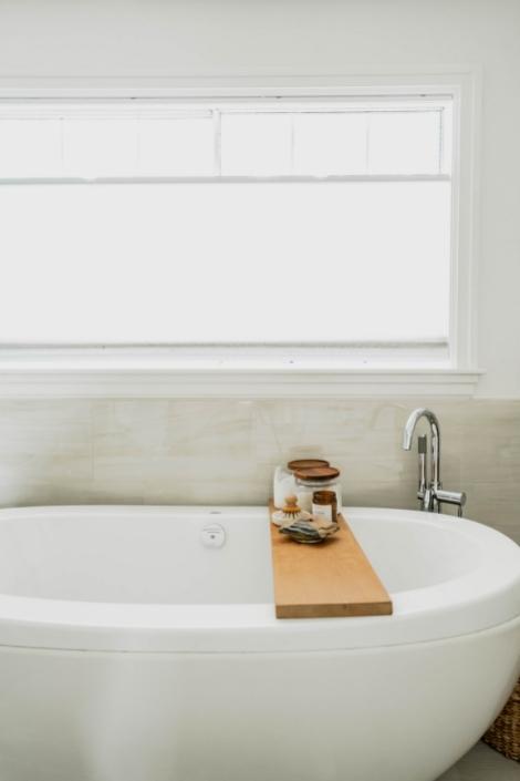 white vessel tub, window, wood bath tray
