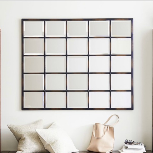 A multi-panel large mirror made of wood.
