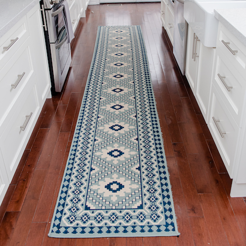 Long area rug with a white and blue pattern