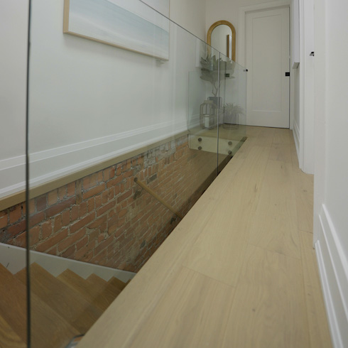 Clear railings in small hallway