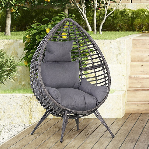 A tear-drop shaped gray egg chair outdoors.
