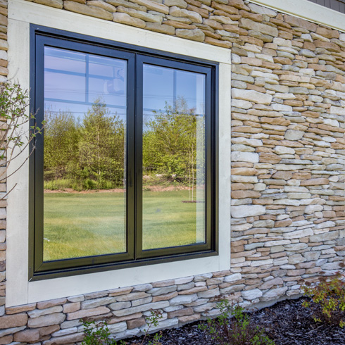 supreme casement windows with black exterior and craftsman grille pattern