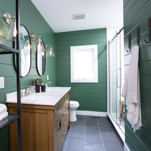 Modern cottage bathroom with dark green walls and a dark wooden vanity