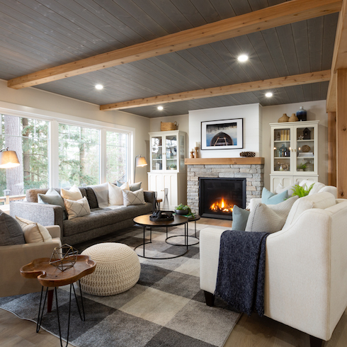 Renovated living room with exposed wooden beams and a fireplace