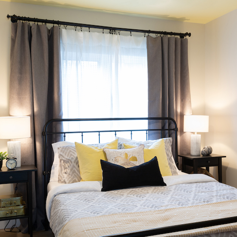 Renovated cottage bedroom with dark grey, white and yellow accents