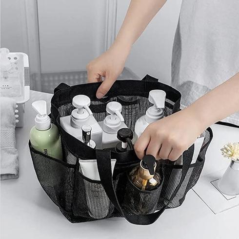 A black shower caddy filled with bottles of haircare.