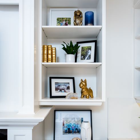 Open shelving with artwork and photographs
