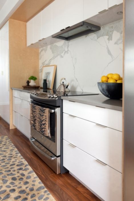 white kitchen, steel stove, printed runner, bowl of lemons