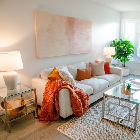 Warm white living room with orange accents