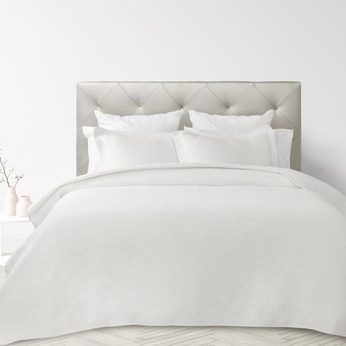 White bedding in a white bedroom.