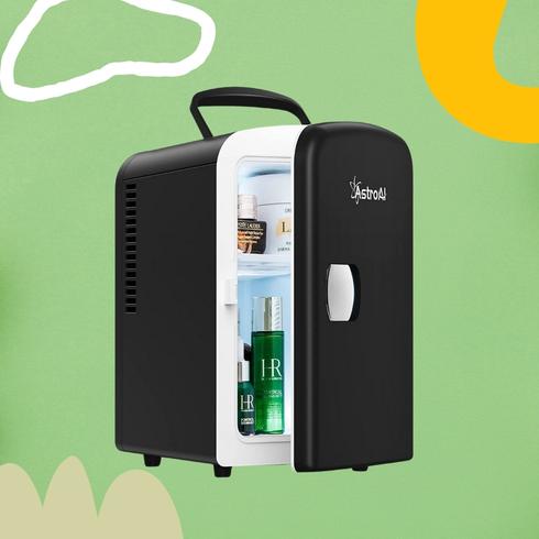 A black mini fridge with a green background.