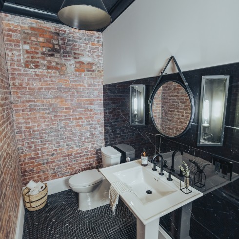 Moody bathroom with exposed brick