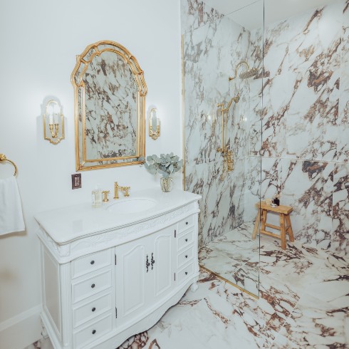 Bathroom with marble and gold accents